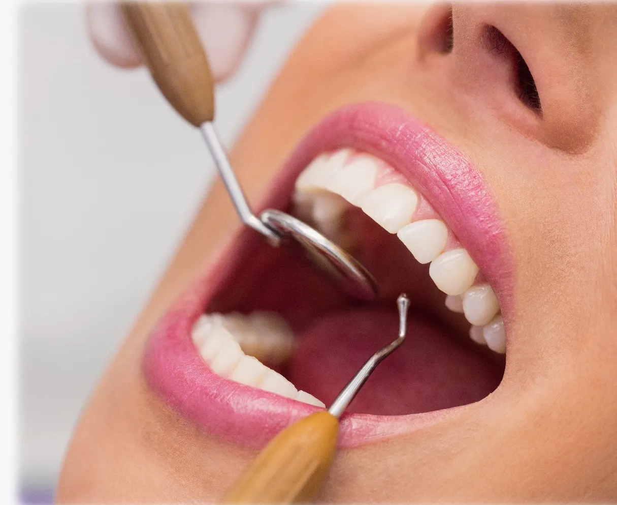 Dentist examining a patient's teeth for dental prosthesis